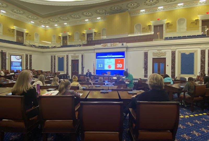 Girl Scouts participating in workshops and convening to vote on a data privacy draft bill in a full-scale replica of the US Senate Chamber.