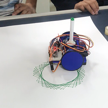 An Arduino powered robot with a marker attached to it draws a circular geometric pattern.